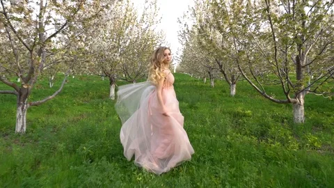 Slow motion following back five years age brunette girl with blue dress running Stock Footage 128435117