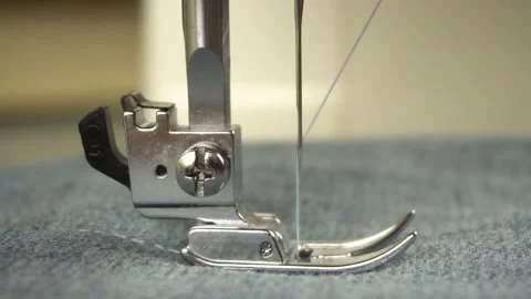 Slow motion of the foot and needle while sewing on the sewing machine.Close-up. Video stock 140052697