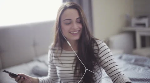 Slow motion footage with athletic handsome girl who listens to the music through Stock Footage 61335204