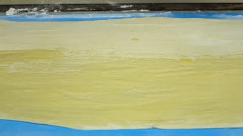 Slow motion footage. Baker hand smears an egg dough Stockbeeldmateriaal 88452580