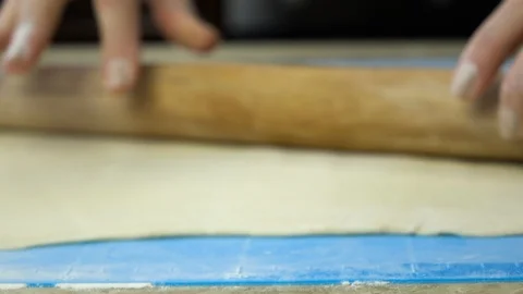 Slow motion footage. Baker hand kneading dough with rolling pin Stockbeeldmateriaal 88452671