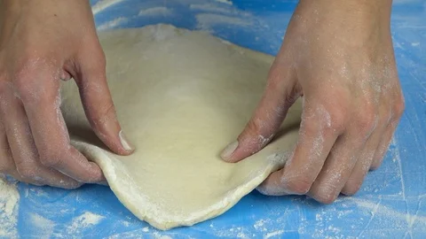 Slow motion footage. Baker hand kneading and stretching dough with rolling pin 库存影片 88452756