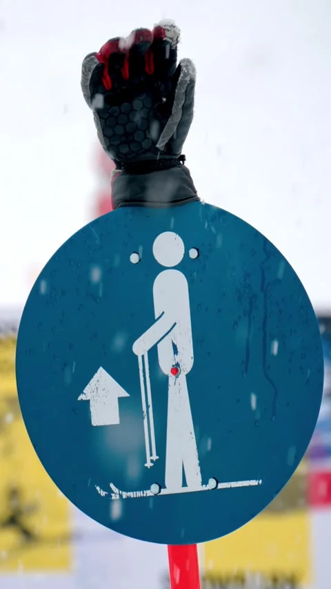 Slow motion footage of blue ski resort lift sign and gloved hand during win.. Stock Footage 339343208