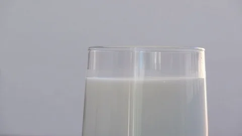Slow motion footage of a chocolate digestive biscuit being dunked into a Stock Footage 98975452