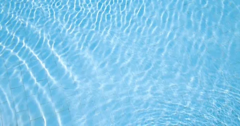 Slow motion footage of crystal clear blue swimming pool water gentle ripple.. Stock Footage 338057492