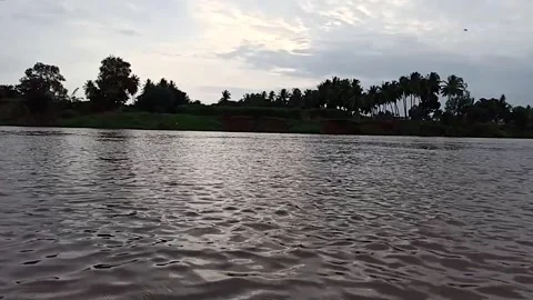 Slow motion footage. Evening sunset reflection on krishna river water. Stock Footage 138323217