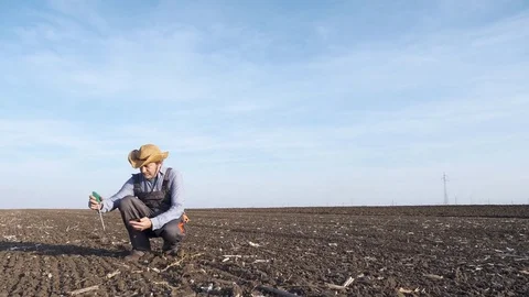 Slow motion footage of the farmer analyzing the field soil Stock Footage 82363217