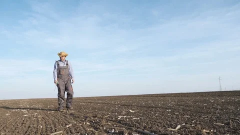 Slow motion footage of the farmer analyzing the field soil Stock Footage 82364936
