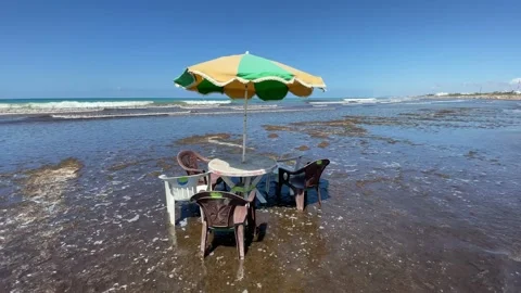 Slow-motion footage of a Free table with many chairs and a parasol for rental Stock Footage 162893290