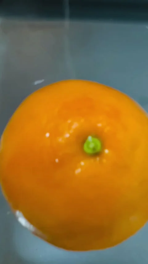 Slow Motion Footage of Fresh Orange Dropping into Water Stock Footage 337741131