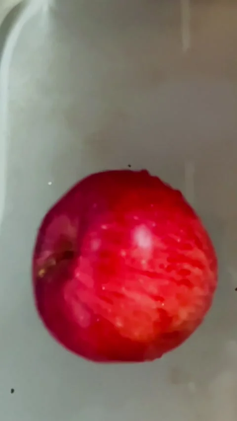 Slow Motion Footage of Fresh Red Apple Dropping into Water Stock Footage 337741123