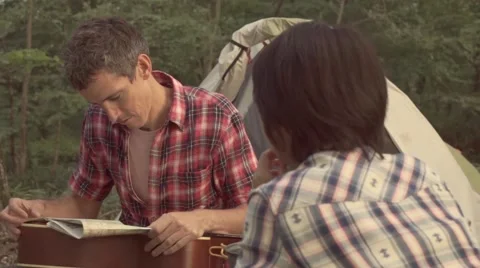 Slow motion footage of friends checking map at a camp site, Yamanashi Prefecture Stock Footage 58467074