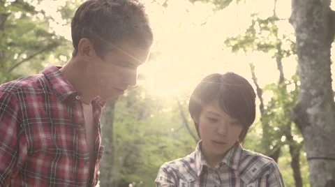 Slow motion footage of friends checking map at a camp site, Yamanashi Prefecture Stock Footage 58467141