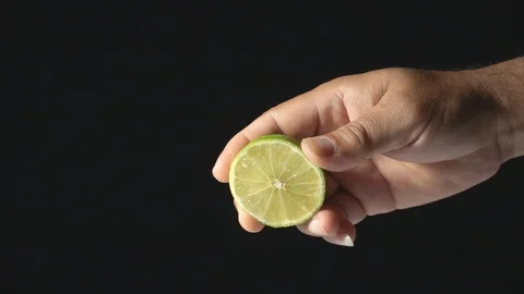 Slow Motion Footage Of Hand Squeezing Juicy Lemon Video stock 113443169