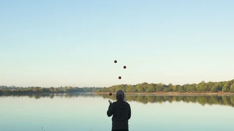 Slow-Motion footage of Juggler overlooking Pond Video stock 101283187