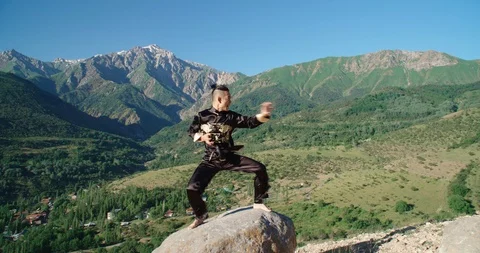 Slow motion footage of a man practicing martial arts. Bright emotions on his Video stock 115877889
