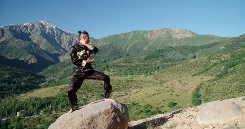 Slow motion footage of a man practicing martial arts. Bright emotions on his Video stock 115882697