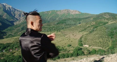Slow motion footage of a man practicing martial arts. Bright emotions on his Video stock 115883193