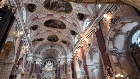 Slow motion footage of the ornate ceiling and frescoes in Schottenkirche Vienna Stock Footage 344430678