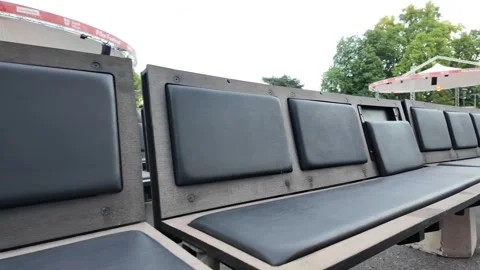 Slow motion footage of a row of empty outdoor chairs in a tranquil space Stock Footage 344432387