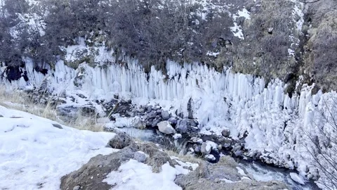 Slow motion footage snow-covered rocks and mountain river, nature exploration Stock Footage 288101019