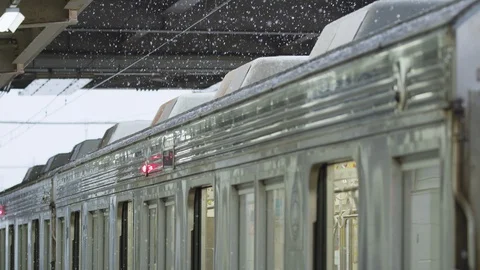 Slow motion footage of snow falling on an electric commuter train Видео 124266517
