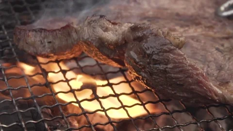 Slow motion footage of steak being cooked on the grill, Tokyo, Japan Stock Footage 77335656