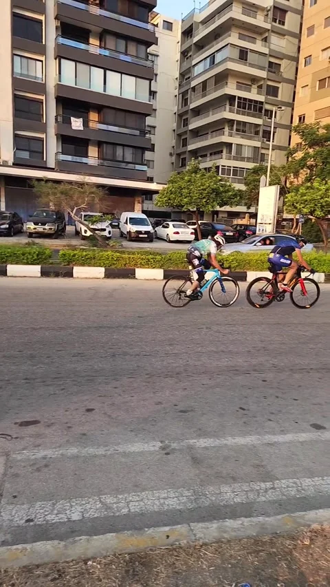 Slow-motion footage of two cyclists on road bikes Stock Footage 313591534