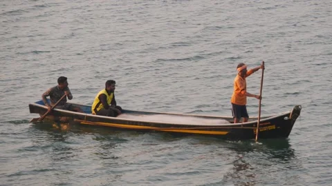 Slow motion footage of two men rowing boat in lake water Stock Footage 150718637