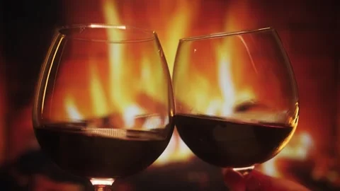 Slow motion footage of two wine flutes against a fireplace background. Stock Footage 241654104