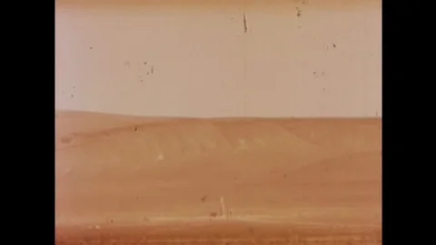 Slow-motion footage of an underground nuclear test explosion, followed by cars Stock Footage 147384882