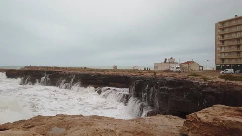 Slow-motion footage of waves violently crashing against rocks Stock Footage 133809185