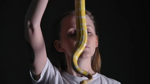 Slow motion footage of woman with python albino crawling on her face Stock-Footage 143960027