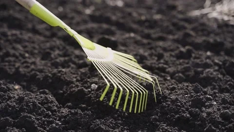 Slow motion footage of a worker grading out the ground to make it level and flat Video stock 130495038