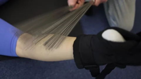 Slow motion forearm massage with flexible metal rods each stroke creates a sooth Stock Footage 306596963