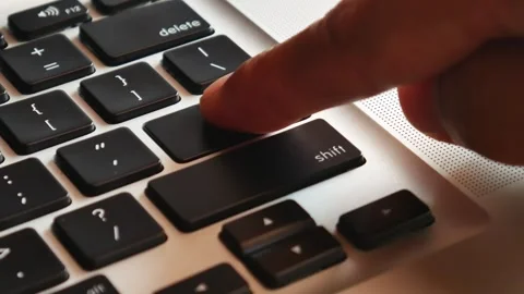 Slow motion of forefinger pressing enter key on modern laptop Video stock 291854409