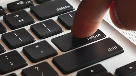 Slow motion of forefinger pressing enter key on modern Video stock 291854718