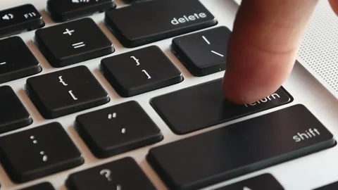 Slow motion of forefinger pressing enter key on modern laptop Stock Footage 291854737