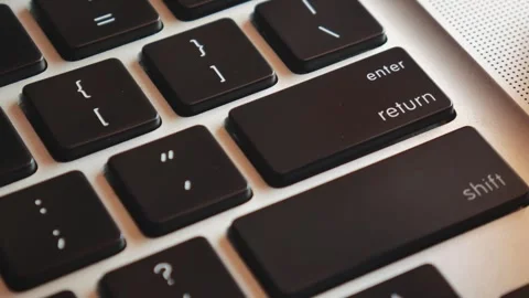 Slow motion of forefinger pressing enter key on modern laptop Stock Footage 291858100