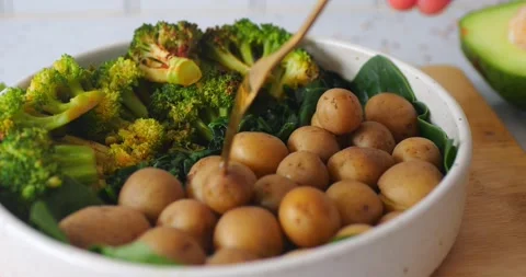 Slow motion of fork piercing baby potato Stockbeeldmateriaal 282764488