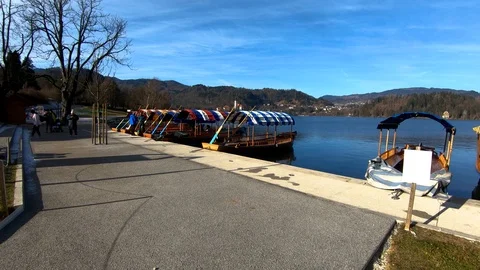 Slow motion forward moving Pletna boat on lake Bled shore Stock Footage 123168523