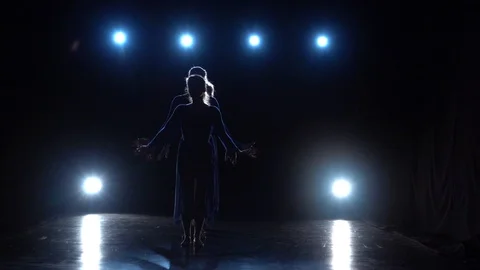 Slow motion of four ballerinas dancing modern ballet over spotlights Stock Footage 111307391