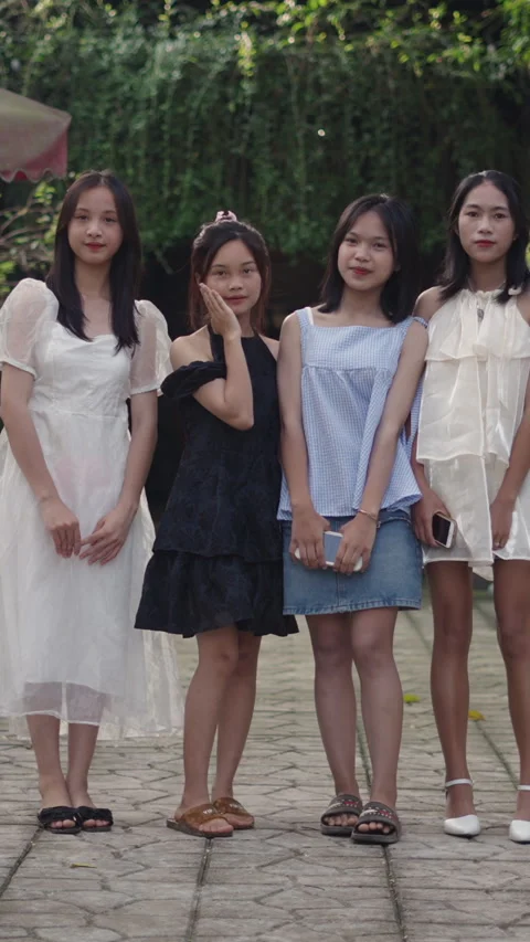 Slow motion four full body young asian teenage girls dressed in stylish summer Stock Footage 276378787