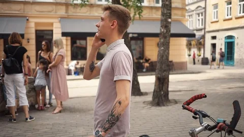 Slow motion frame from the side happy attractive young man use phone stand near Stock Footage 92428380