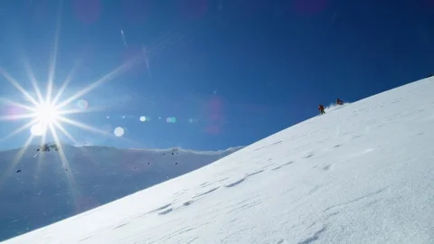 Slow motion of freeride skier and snowboarder carving turns on ungroomed snow Stock Footage 121597838