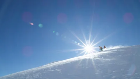 Slow motion of freeride skier and snowboarder having good ride down mountain Stock Footage 121597892