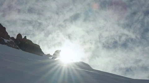 Slow motion of freeride snowboarder spraying snow in camera riding down hill Stock Footage 121597140
