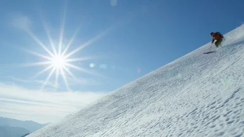 Slow motion of freerider skiing down in high-altitude terrain, Andes mountains Stock Footage 121598010