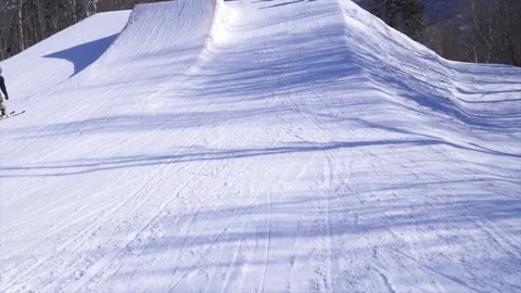 SLOW MOTION Freestyle Skier does underflip of Huge Jump in Terrain Park Stock Footage 129457598