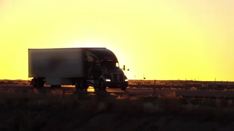 SLOW MOTION: Freight container semi truck driving on the road on sunny morning Stock Footage 81686968